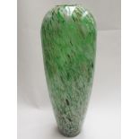 A large glass vase with green, white and gold inclusions,