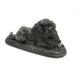 After E. Delabrierre, a bronze of a recumbent lion with prey. Signature in the base.