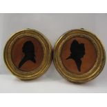 A pair of oval silhouettes of gent and lady, gilt framed, 16cm x 15cm,