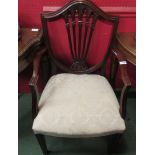 Retailed at "Harrods" a George III style mahogany shield-back elbow chair on square tapering legs