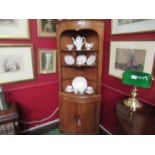 A George III stripped pine bow front corner cupboard,