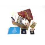 A box of various collector's coinage including silver and proof sets