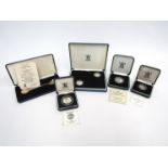 Five silver proof coins including 5p and 10p coin,