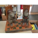 A pair of squirrel form wooden bookends and a chess board