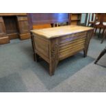 A carved oak storage box with swirled detail