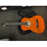 A soft cased Messina classical guitar