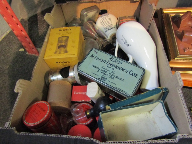 A box of bygone medical equipment including bottles and tins