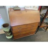 An Edwardian mahogany bureau with inlay detail, drop down top over four drawer base on bracket feet.