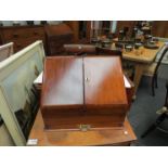 A late Victorian walnut desk stand, the twin doors opening to reveal envelope and pen space,