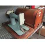 Two cased sewing machines including Singer