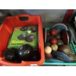Two boxes of sporting equipment including lawn bowls,