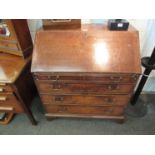 A George III oak bureau, the fall front over four graduating drawers, bracket feet,