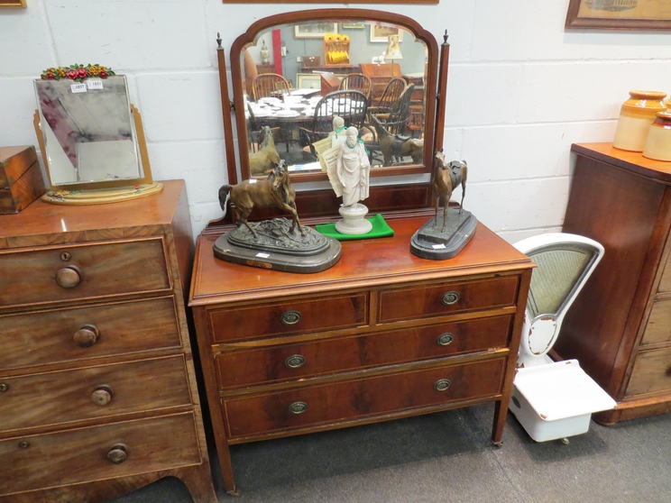 A 1930's walnut dressing chest, the mirror back over two short and two long drawers,