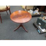 A pair of reproduction mahogany occasional tables on tripod feet