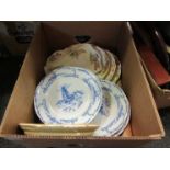 A box containing mostly early 20th Century plates including Delft and windmill decorated