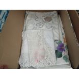 A box containing assorted linen including table cloths,