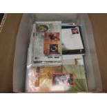 A box containing a collection of mint stamps and first day covers including Harry Potter,