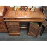 An elm pedestal clerks desk the sloped top over a heavily carved kneehole base,