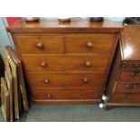 A Victorian mahogany round cornered chest of two short over three long drawers, bun handles,