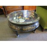 A 20th Century oriental lacqered circular coffee table with mother of pearl and gilt border,