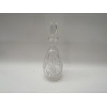 A glass decanter with associated stopper,