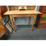 A light oak side table with frieze fall flap revealing sectional interior together with a pine