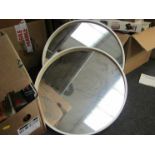 A pair of Ikea circular framed mirrors