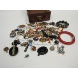 A miniature suitcase containing a quantity of bijouterie including bracelets, necklaces,