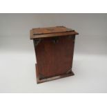 A late Victorian oak desk stand, the mounted lid and front opening to reveal letterspace,