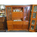 A modern oak dresser with glazed cupboards above drawer and cupboard base, 186cm tall,