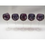 A set of five hock glasses with amethyst coloured floral etched design bowls