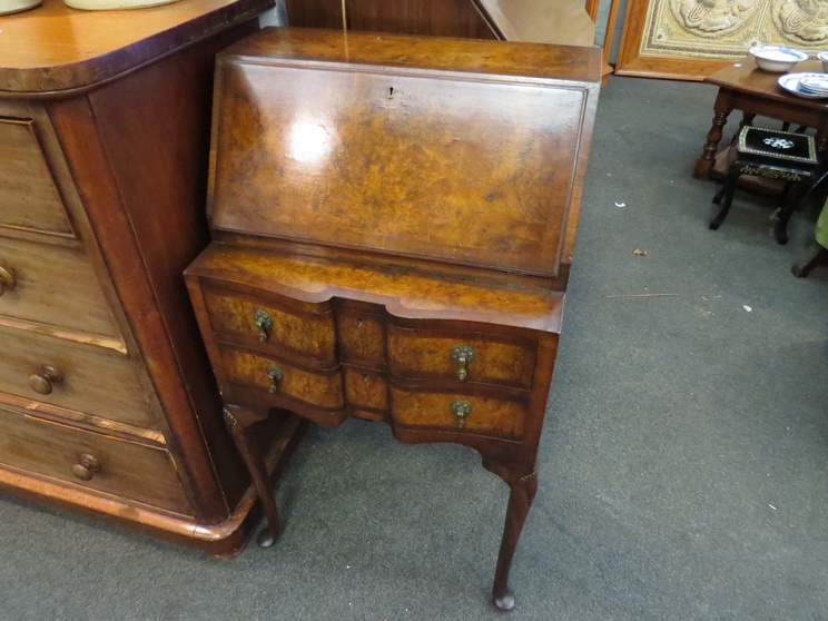 A Queen Anne style bureau with drop-flap over two drawers on pad feet,