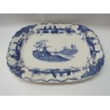 A Delft style blue and white meat plate with scenes of boats and windmills,