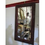 A foliate carved hardwood wall mirror,