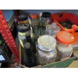 A box of vintage shop containers and bottles
