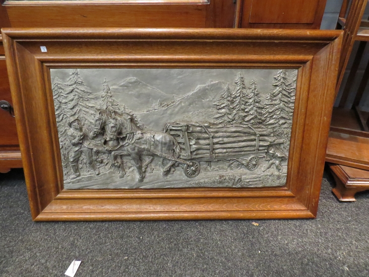 A resin relief picture depicting a man horses with timber wagon, signed Felix,