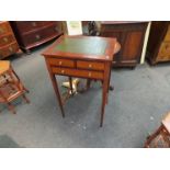 An Edwardian style mahogany miniature writing table with green leather top over three frieze