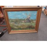 M KIDNER (XX) An oil on board of windmill and settlement beside river, gilt framed,