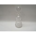 A glass decanter with associated stopper,