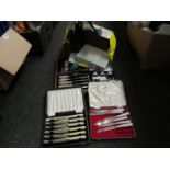 A quantity of cased cutlery sets including cake forks