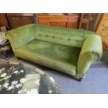 A Victorian drop-end sofa with green buttoned velour upholstery,