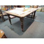 A Circa 1900 walnut extending dining table with reeded and turned legs to castors