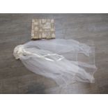 A 1920's wedding veil in a vintage Harrod's box