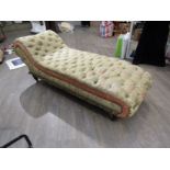 A Victorian deep button back chaise lounge with pale green and coral silk foliate upholstery,