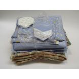 Bundles of upholstery fabrics including pale blue glazed cotton fabric