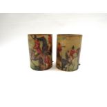 A pair of cylindrical fibreglass lamp shades depicting huntsmen in scarlet jackets on horseback