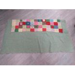 A middle 20th Century hand crocheted blanket stitched onto a fine wool background