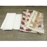 A mid 20th Century patchwork quilt and two white table cloths