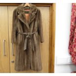 A Tissavel faux fur pale brown coat with self tie belt