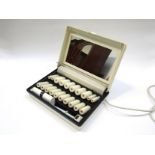A box of 1970's Carmen heated rollers with clips and integral light